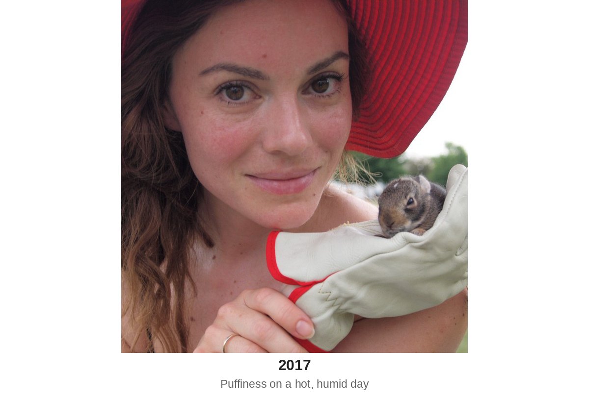 Holly in 2017 wearing a red hat and holding a baby bunny, with puffiness in her face on a hot, humid day